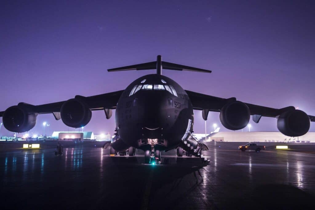 A military aircraft on the runway at night
