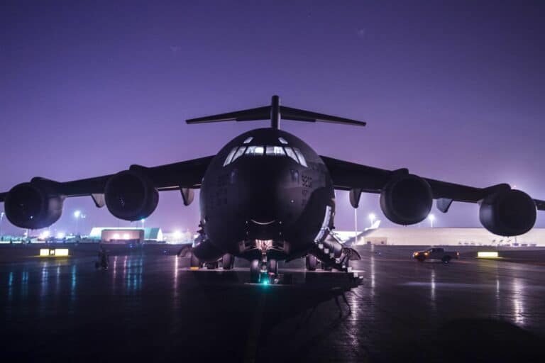 A military aircraft on a flightline at night