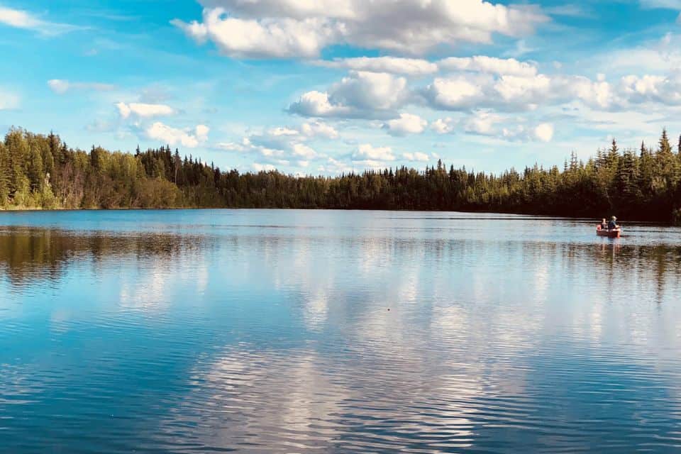 A calm lake with a fishing boat