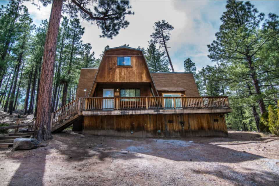 A large A-frame cabin in the woods