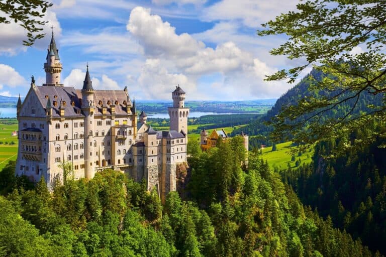 A fairytale castle in the lush green bavarian alps.