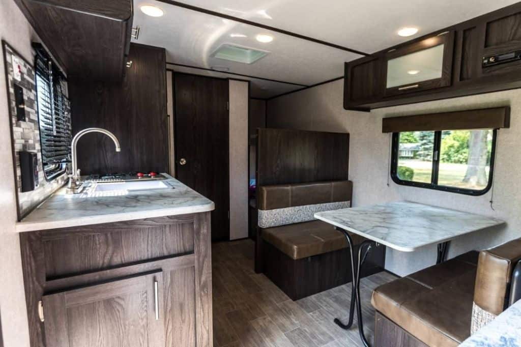 The kichen and seating area inside a travel trailer