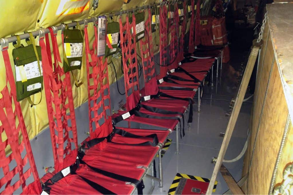 red jump seats along the sides of a military tanker