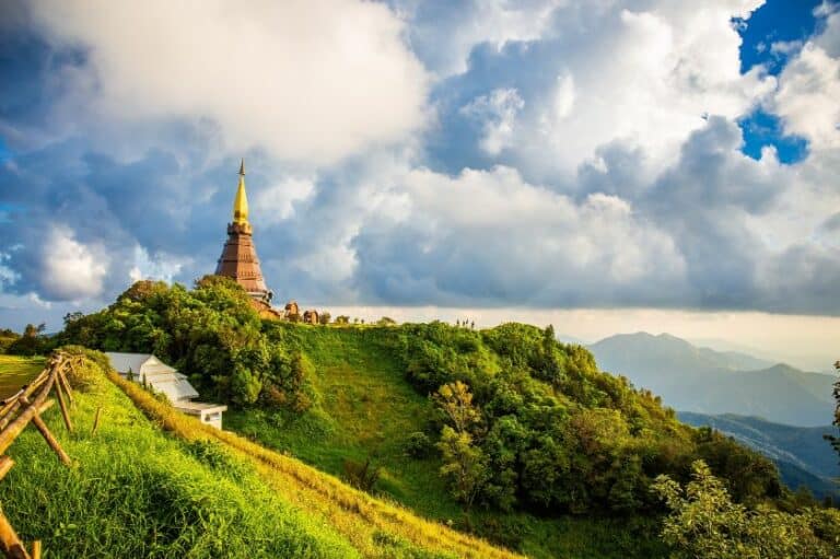 Lush green hills with a an ornate building in the background