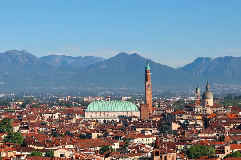 mountains frame the red rooftops of vicenza