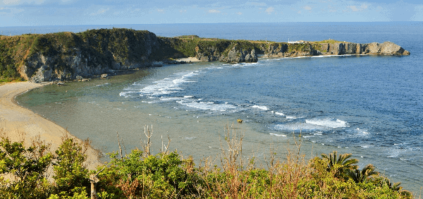 Things to do in Okinawa - view of Cape Hedo from a nearby beach - Poppin' Smoke